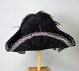 Black Tricorn Pirate hat with silver trim, black lace and black feathers, back view